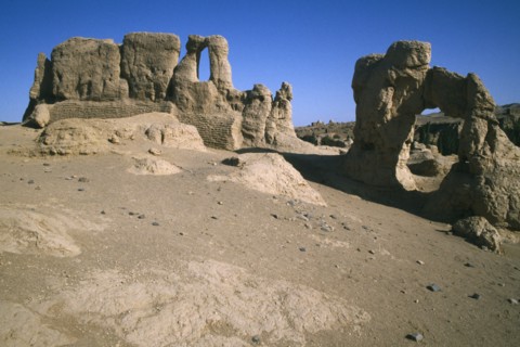 CHINA, Xinjiang, Jiaohe ruins, View of ruined buildings in rocky arid landscape