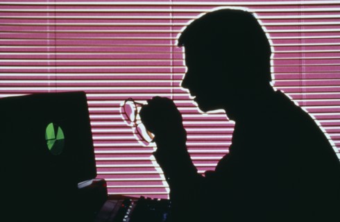 INDUSTRY, Office, Computers, Silhouette of a man on a computer holding glasses and looking at the