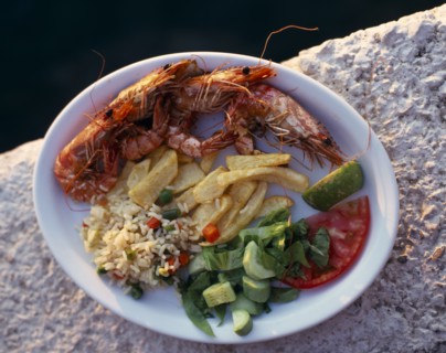 FOOD, Seafood, "Plate of shrimps with rice, chips and salad Greek tourist meal"