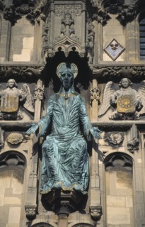 ENGLAND, Kent, Canterbury Cathedral, Green statue of Christ mounted on the ornate stone facade