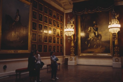 RUSSIA, St Petersburg, "The Hermitage Museum interior, room hung with portaits, three people look