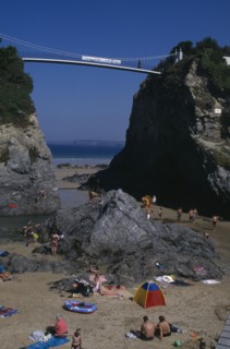 ENGLAND, Cornwall , Newquay, "Partial view of town beach, children play at the foot of two large