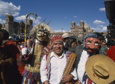 PERU, Cusco Department, Cusco, "Group of musicians and masked dancers in traditional costume at