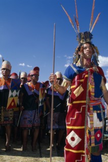 PERU, Cusco Department, Cusco, Male figure in traditional costume and feathered headress at Inti