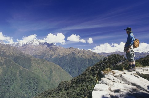 PERU, Cusco Department, Inca Trail, Man standing on high ridge looking out towards the Vilcabamba