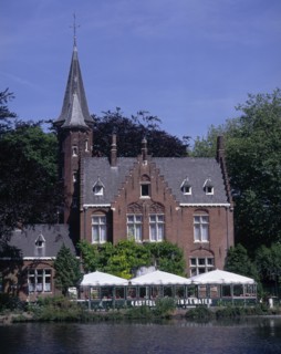 BELGIUM, West Flanders, Bruges, "View across Minnewater or Love Lake, towards red brick building