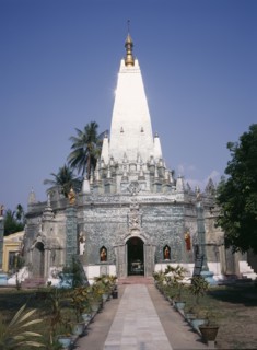 MYANMAR, Yangon, "Buddhist temple exterior with the sun reflecting off the silver spire, view along
