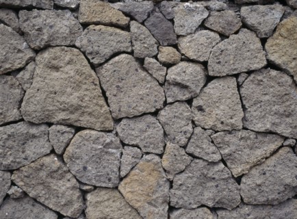 INDONESIA, Bali, Lovina, Detail of dry stone wall at Kalibukbuk