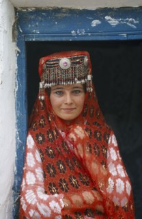 CHINA, Tienshan, Tashgurgen, Tajik girl in traditional costume at house on the Silk Route