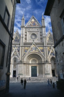 ITALY, Umbria, Orvieto, The Duomo facade partly viewed through a narrow street.