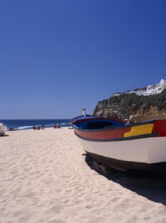 PORTUGAL, Algarve, Carvoeiro, Colourful fishing boat on the beach
