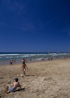 PORTUGAL, Algarve, Praia da Rocha, View along beach with children playing beach soccer