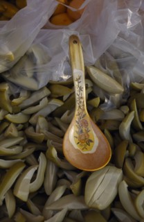 MALAYSIA, Kedah, Langkawi, Spoon in a bowl of green mangoes with vinegar on a stall at the Night