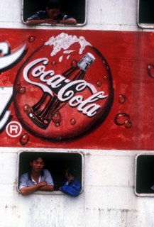 VIETNAM, Mekong Delta, Vinh Long, "Advertisment for Coca Cola on the side of a ferry, passengers at