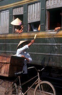 VIETNAM, Lang Son Province, Lang Son, Ice cream seller with bicycle beside train.