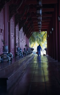 MALAYSIA, Kedah, Langkawi, The Summer Palace on Pantai Kok beach with woman sweeping the floor of