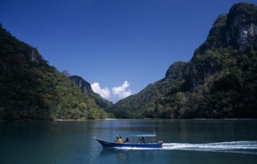 MALAYSIA, Kedah, Langkawi, Pulau Dayang Bunting island with a traditional covered boat used for