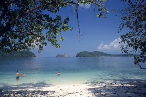 MALAYSIA, Kedah, Langkawi, Pulau Singa Besar wildlife reserve island with tourists swimming in the