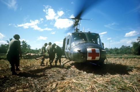 VIETNAM, Quang Nam-Danang, Hoi An, Area South of Danang.  Wounded soldier being put on a red cross