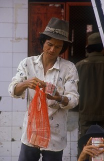 CAMBODIA, Neak Long, Money changer at the Neak Long ferry.