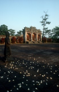 VIETNAM, Hue, Minh Mang Tomb.  View across courtyard scattered with flowers towards ruins with