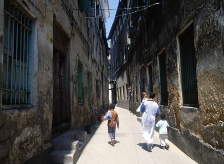 TANZANIA, Zanzibar Island, Zanzibar, "Stone Town.  Young man and three children walking along