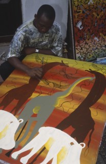 TANZANIA, Zanzibar Island, Arts and Crafts, Local artist working on painting in the Tingatinga