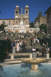 ITALY, Lazio, Rome, Piazza di Spagna.  Fountain in the foreground with people on the Spanish Steps