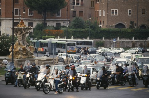 ITALY, Lazio, Rome, Busy road with lines of waiting cars and scooters.