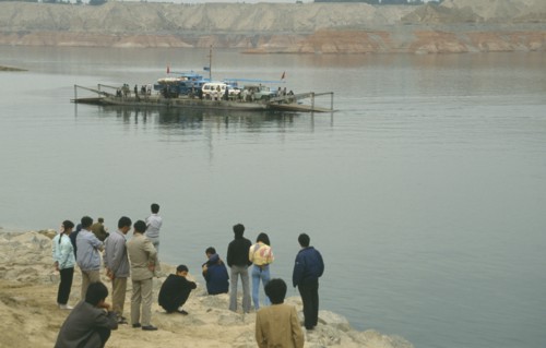 CHINA, Gansu Province, Yellow River, Linjiaxia Reservoir  with people waiting for the ferry