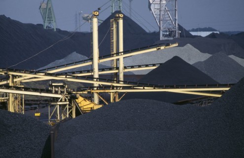 BELGIUM, Antwerpen, Antwerp, Coal stacked high on the docks