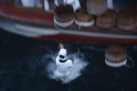 JAPAN, Honshu, Toba, Traditional Mikimoto pearl diver jumping from a boat into the water