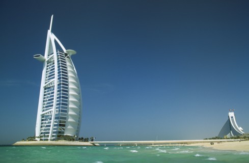 UAE, Dubai, The Burj-al-Arab Hotel with the Jumeirah Beach Hotel in the distance behind.