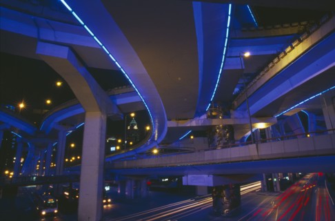CHINA, Shanghai, "Bridge and intersecting roads seen from below, lit by ultra violet light at night