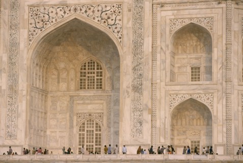 INDIA, Uttar Pradesh, Agra, "The Taj Mahal, detail of patterned marble walls with visitors below."