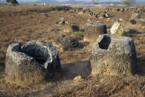 LAOS, Near Phonsavan, Plain Of Jars, Stone jars of unknown origin in the ground with lids fallen