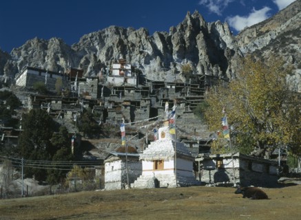 NEPAL, Annapurna Region, Braga, Village near Manang.  Flat roofed stone houses and stupa hung with