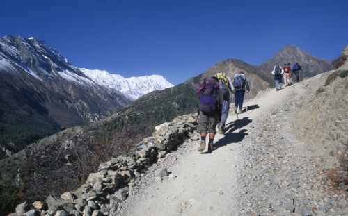 NEPAL,  , Annapurna, "Group of trekkers carrying rucksacks walking up steep mountain path, seen