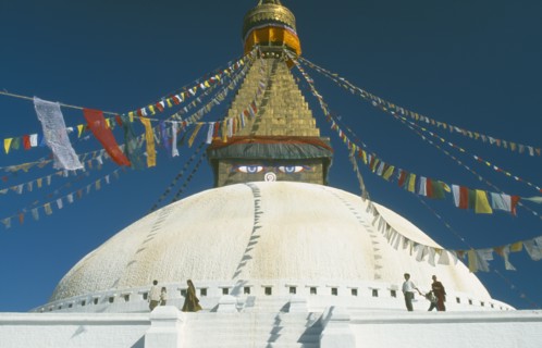 NEPAL, Kathmandu, Bodhnath Stupa, Detail of white dome with visitors circling it clockwise and