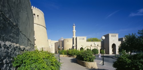 OMAN, Nizwa, "Town centre with crenellated walls surrounding quiet, open, paved area with raised