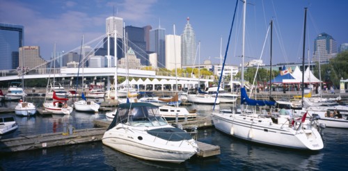 CANADA, Ontario, Toronto, Harbourfront Park.  View over moored boats towards city skyline behind.