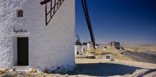 SPAIN, Castilla La Mancha, Line of white painted windmills.