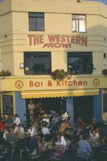 ENGLAND, East Sussex , Brighton, City bar and restaurant with open front and people sitting at