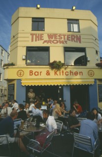 ENGLAND, East Sussex , Brighton, City bar and restaurant with open front and people sitting at