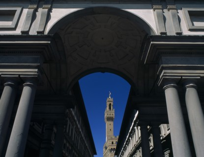 ITALY, Tuscany, Florence, Palazzo Vecchio.  View through colonnaded archway towards the Campanile.