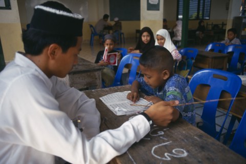 THAILAND, Chiang Mai, "Children studying the Koran at Chiang Mai Mosque under the supervision of a
