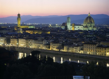 ITALY, Tuscany, Florence, View over city at dusk with the Duomo illuminated and street lights