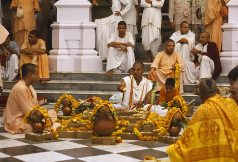 INDIA, Utter Pradesh, Vrindaven, Monks and worshippers on temple steps.   Dirwali festival?