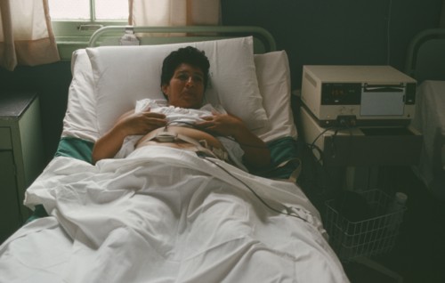 CUBA, Havana, Pregnant mother in hospital bed attached to monitor