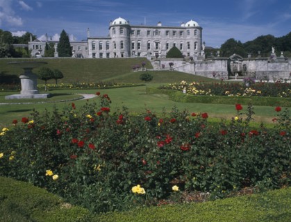 IRELAND, County Wicklow, Powerscourt House, View over formal gardens towards exterior facade.